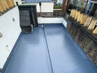 Renewed flat roof showing Sika Liquid Plastic coating after replacing rotten timbers and laying new solid insulation in London
