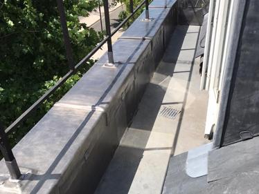 New code 5 lead capping to wall, welded & cut it into shape to replacing torch on felt to provide better, long-term solution