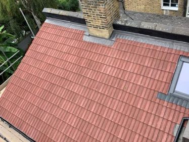New Redland 49 tiled roof with code 4 lead cover flashings and new Velux roof light for a property in Fulham, London