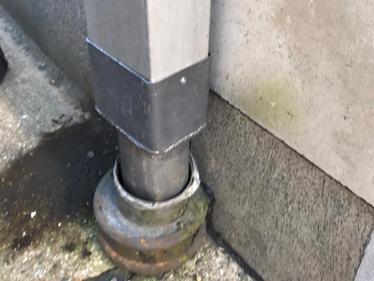 New converter from rectangular downpipe into a round gulley fabricated out of lead at a property in  Hammersmith, London