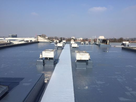 Renewed Hilton Hotel roof with cold applied liquid membrane & anti-slip walkway for maintenance access with 20 year guarantee