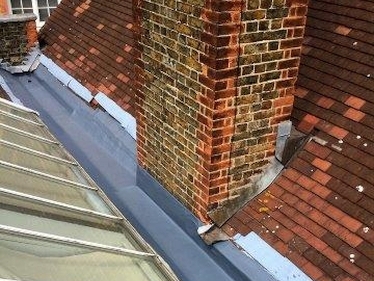 New gutter laid with carrier membrane & covered with liquid coating & flashing detail renewed with Ubi-Flex at Brixton school