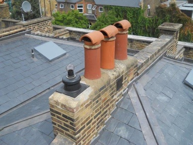 Renewed roof with Spanish slates, lead centre gutter & expansion joints, lead cover flashings and lead hips in Clapham London