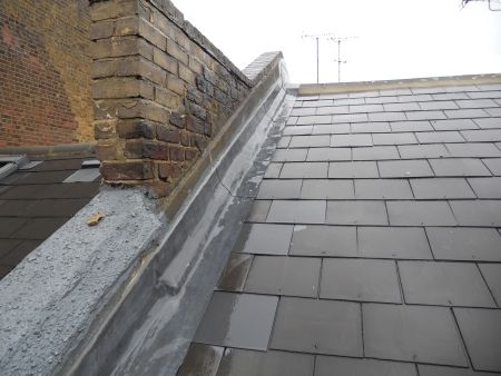 roof repair of a pitched slate roof with new slate tiles & lead flashing after an investigation to pinpoint the cause of water leaks and roof defects